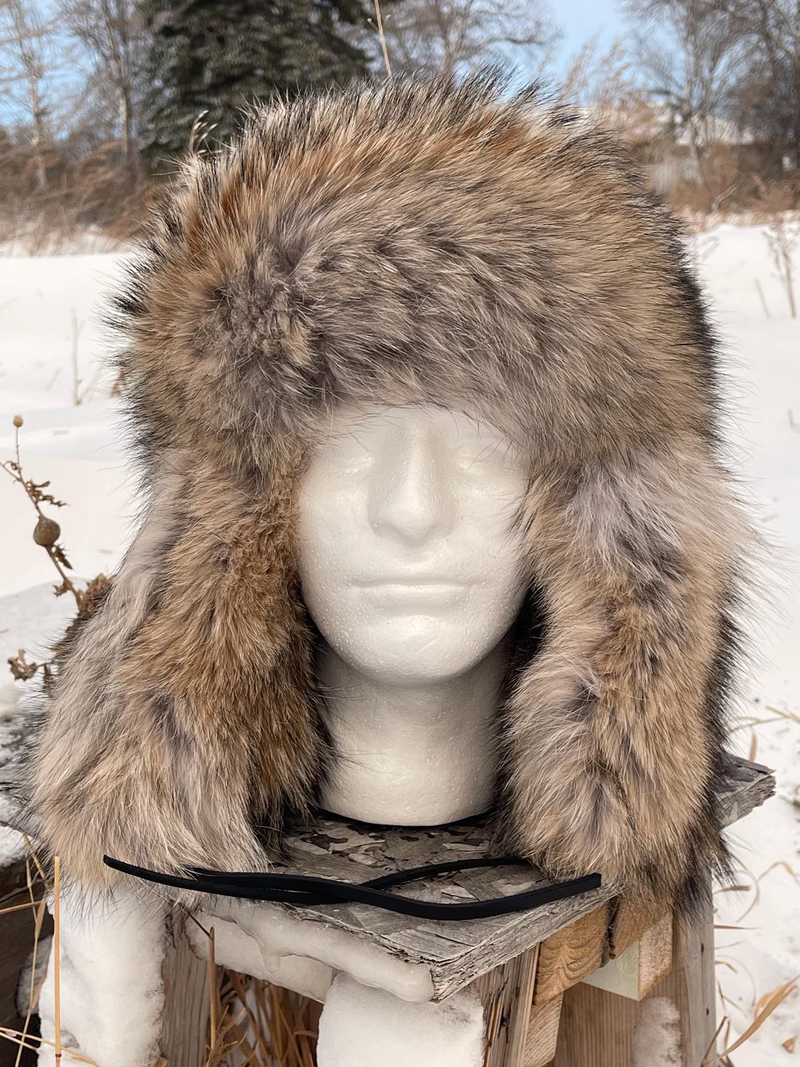 Fur hat on a mannequin head with a snowy background